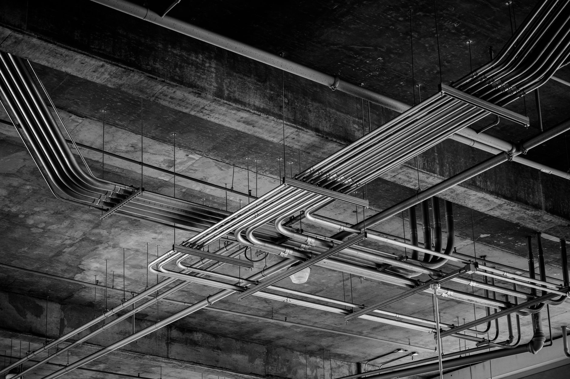Black and white photo of industrial ceiling with metal pipelines in Boise, ID