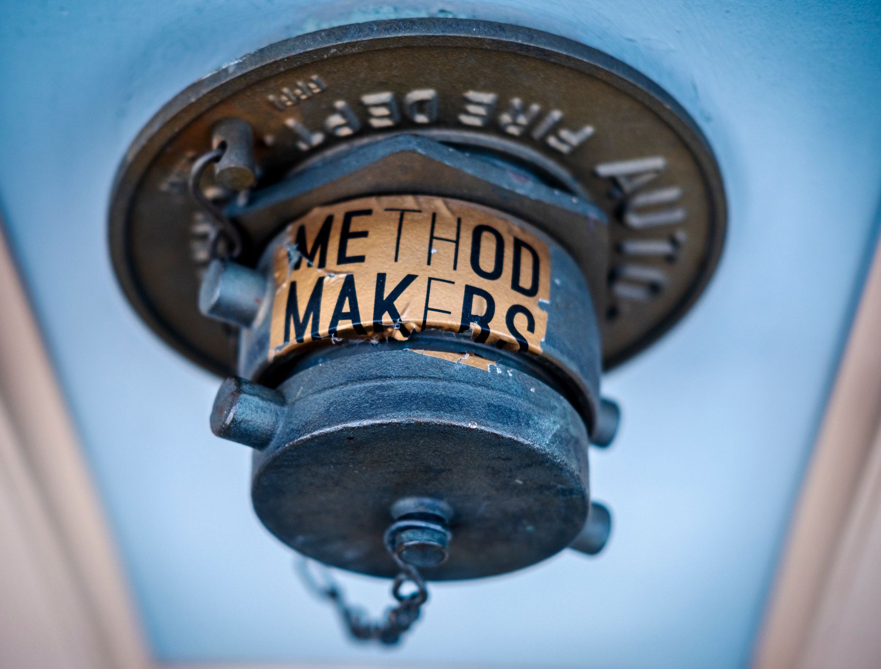 Blue vintage fire sprinkler head with metallic texture and Method Makers label